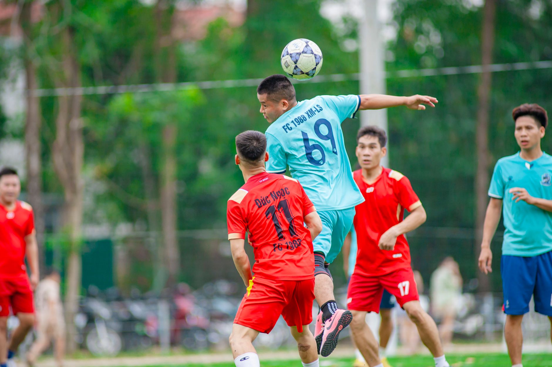 Pemain sedang beraksi selama pertandingan sepak bola di Hà Nội, menangkap gerakan dinamis.