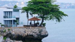 Pemandangan indah sebuah rumah dan gazebo di tebing yang menghadap ke laut, memberikan pelarian yang damai.